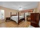 Cozy primary bedroom features wood floors, a ceiling fan, and natural light at 333 Lake Howard Dr Nw # 204D, Winter Haven, FL 33880