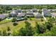 Scenic aerial view showcasing backyard pools and ample green space with lush trees at 3447 Feathergrass Ct, Harmony, FL 34773