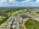 Wide aerial shot capturing the community's homes, golf course, ponds, and the vast surrounding landscape at 3447 Feathergrass Ct, Harmony, FL 34773