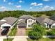 Beautiful aerial view of a neighborhood home with lush landscaping and a private driveway at 3447 Feathergrass Ct, Harmony, FL 34773