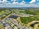 An aerial view of houses near golf courses and a beautiful lake in a golf community at 3447 Feathergrass Ct, Harmony, FL 34773