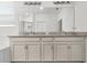 Bright bathroom featuring a double vanity with granite countertops and a large mirror at 3447 Feathergrass Ct, Harmony, FL 34773