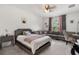 Bright bedroom featuring a large bed, sectional couch, neutral carpet, and natural light from a window at 3447 Feathergrass Ct, Harmony, FL 34773