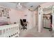 Bright pink bedroom with a charming ceiling fan, desk space, and easy access to a walk-in closet at 3447 Feathergrass Ct, Harmony, FL 34773
