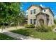 Charming two-story home featuring a stone-accented entrance and a well-manicured lawn at 3447 Feathergrass Ct, Harmony, FL 34773