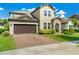 Charming two-story home featuring a brick driveway, attached two-car garage and a stone-accented entryway at 3447 Feathergrass Ct, Harmony, FL 34773