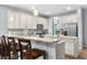 Open-concept kitchen with stainless steel appliances, a large island, granite countertops and a breakfast bar at 3447 Feathergrass Ct, Harmony, FL 34773