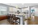Open-concept kitchen with stainless steel appliances, a large island, granite countertops and a breakfast bar at 3447 Feathergrass Ct, Harmony, FL 34773