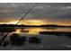 Enjoy tranquil evenings fishing from the lake, offering a serene escape and beautiful sunset views at 3447 Feathergrass Ct, Harmony, FL 34773