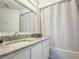 Bathroom features a white vanity with granite countertop and shower with white curtain at 3592 Southpointe Dr # 2, Orlando, FL 32822