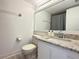 Bathroom featuring a toilet and white vanity with granite countertop; clean and functional at 3592 Southpointe Dr # 2, Orlando, FL 32822