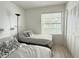 Bedroom featuring two twin beds with black and white pillows, and closet with louvered doors at 3592 Southpointe Dr # 2, Orlando, FL 32822