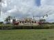 The Ventura Country Club entrance sign is framed by lush landscaping and palm trees, welcoming residents and guests at 3592 Southpointe Dr # 2, Orlando, FL 32822