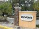 The South Pointe community sign features a stone pillar and decorative landscaping, creating an inviting entrance at 3592 Southpointe Dr # 2, Orlando, FL 32822