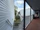 Exterior walkway featuring gray siding, white railings, and brick floor at 3592 Southpointe Dr # 2, Orlando, FL 32822