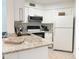 Functional kitchen featuring white cabinetry, granite countertops, and modern appliances at 3592 Southpointe Dr # 2, Orlando, FL 32822