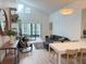 Bright living and dining area featuring vaulted ceilings, modern furnishings, and a sliding glass door to the lanai at 3592 Southpointe Dr # 2, Orlando, FL 32822