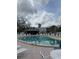 Community pool surrounded by lounge chairs offers a relaxing outdoor space at 3592 Southpointe Dr # 2, Orlando, FL 32822