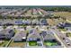 Neighborhood aerial view shows many houses with solar panels in a sunny suburban community at 372 Meadow Pointe Dr, Haines City, FL 33844