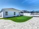 Spacious backyard with a putting green, trampoline, and paver patio at 372 Meadow Pointe Dr, Haines City, FL 33844