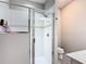 Bathroom featuring a glass-enclosed shower with a tiled surround at 372 Meadow Pointe Dr, Haines City, FL 33844