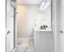 The bathroom has white vanity with a large mirror and walk-in shower at 372 Meadow Pointe Dr, Haines City, FL 33844
