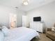 This bedroom has light gray walls, white trim, and a ceiling fan with light at 372 Meadow Pointe Dr, Haines City, FL 33844