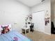 Bright bedroom with cute decor, a well-lit desk area, and a closet at 372 Meadow Pointe Dr, Haines City, FL 33844