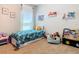 Bright bedroom with colorful bedding, plush toys, and framed wall art at 372 Meadow Pointe Dr, Haines City, FL 33844