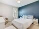 Inviting bedroom with a plush bed, navy accent wall, soft lighting, and minimalist décor at 372 Meadow Pointe Dr, Haines City, FL 33844