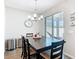 Dining area features modern chandelier, wood-look floors, and sliding glass doors to a screened lanai at 372 Meadow Pointe Dr, Haines City, FL 33844