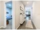 Inviting hallway with wood floors, stylish decor, and doorway view to bedroom with blue bedding at 372 Meadow Pointe Dr, Haines City, FL 33844