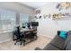 Functional home office featuring a large desk, ergonomic chairs, dual monitors, and comfortable seating at 372 Meadow Pointe Dr, Haines City, FL 33844