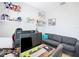 Cozy home office setup with multiple monitors, comfortable seating, and shelving for display at 372 Meadow Pointe Dr, Haines City, FL 33844