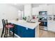 Bright kitchen featuring stainless steel appliances, white cabinetry, and modern island with seating at 372 Meadow Pointe Dr, Haines City, FL 33844