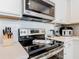 Modern kitchen featuring stainless steel appliances, and white countertops with subway tile backsplash at 372 Meadow Pointe Dr, Haines City, FL 33844