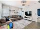 Spacious living room features a large sectional sofa, area rug, mounted tv, and lots of natural light at 372 Meadow Pointe Dr, Haines City, FL 33844
