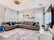 Comfortable living room featuring a large sectional sofa, area rug, mounted TV, and lots of natural light at 372 Meadow Pointe Dr, Haines City, FL 33844