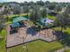 Aerial view of neighborhood playground featuring climbing structures, swings, and picnic area at 372 Meadow Pointe Dr, Haines City, FL 33844