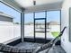 Comfortable screened porch with black and white hammock overlooking the backyard at 372 Meadow Pointe Dr, Haines City, FL 33844