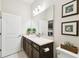Bright bathroom featuring a large mirror, vanity with a white countertop and decoratively framed artwork at 3775 Via Mazzini Ct, Kissimmee, FL 34759