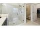 Bathroom showing frameless glass shower with built-in seat, plus commode area and walk-in closet beyond at 3775 Via Mazzini Ct, Kissimmee, FL 34759