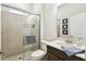 Bathroom showing glass shower with built-in seat, plus commode area and vanity at 3775 Via Mazzini Ct, Kissimmee, FL 34759