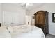 Bedroom with a queen bed, accent pillows, and matching antique wardrobe at 3775 Via Mazzini Ct, Kissimmee, FL 34759