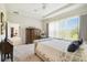 Cozy bedroom features a tray ceiling, plush carpet, and an airy view at 3775 Via Mazzini Ct, Kissimmee, FL 34759