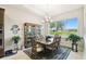 Bright dining room featuring a chandelier, a large window with views, and hardwood floors at 3775 Via Mazzini Ct, Kissimmee, FL 34759