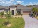 Charming single-story home featuring a manicured lawn and a brick-paved driveway leading to a two-car garage at 3775 Via Mazzini Ct, Kissimmee, FL 34759