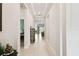 Bright hallway features tray ceilings and light wood flooring, leading to an open living area at 3775 Via Mazzini Ct, Kissimmee, FL 34759
