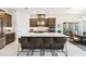 Bright kitchen featuring a large island with seating, stainless steel appliances, and wood cabinetry at 3775 Via Mazzini Ct, Kissimmee, FL 34759