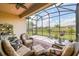 Enjoy the view from this covered screened patio with comfortable seating and lush landscaping at 3775 Via Mazzini Ct, Kissimmee, FL 34759